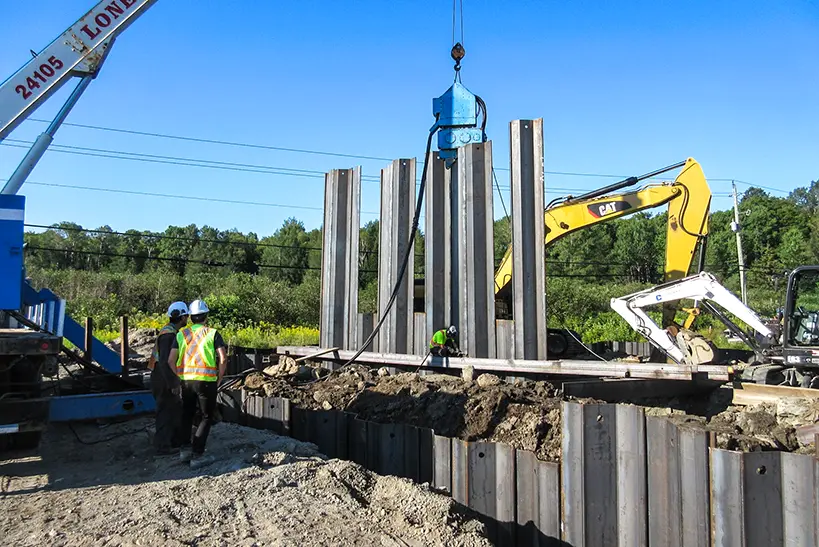 Vibro hammer installing sheet piling.