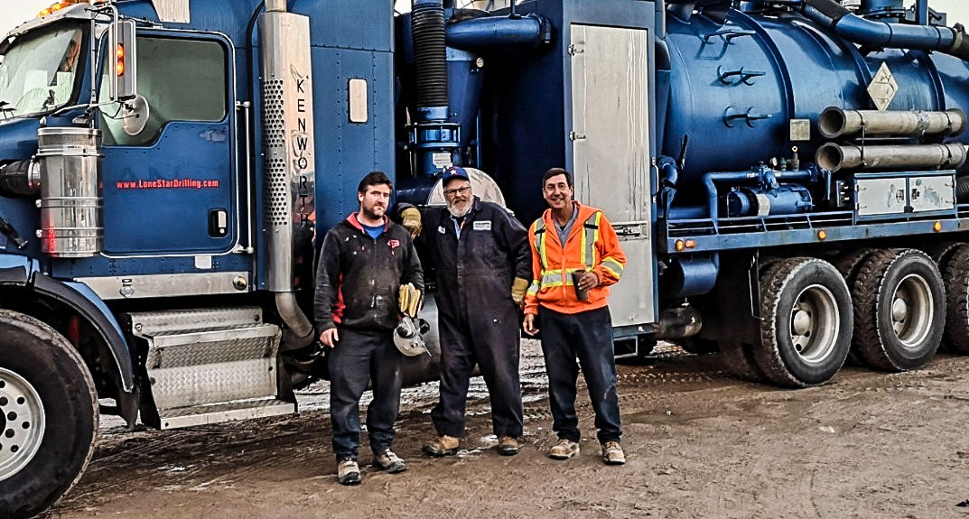 Lone Star Drilling crew standing infront of a Hydrovac Truck